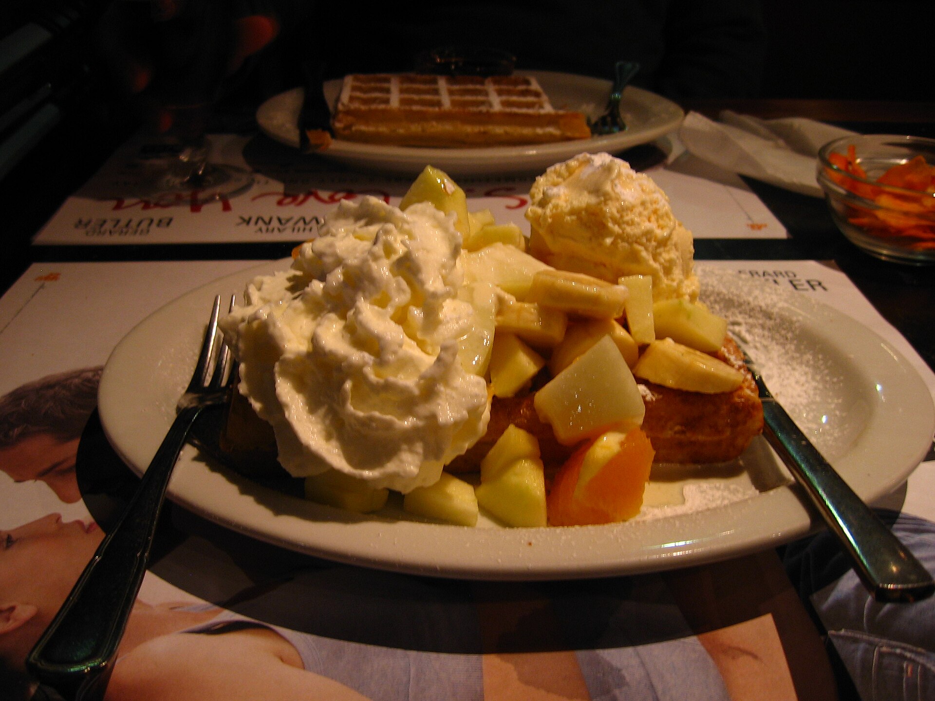 A Belgian waffle served with fruit